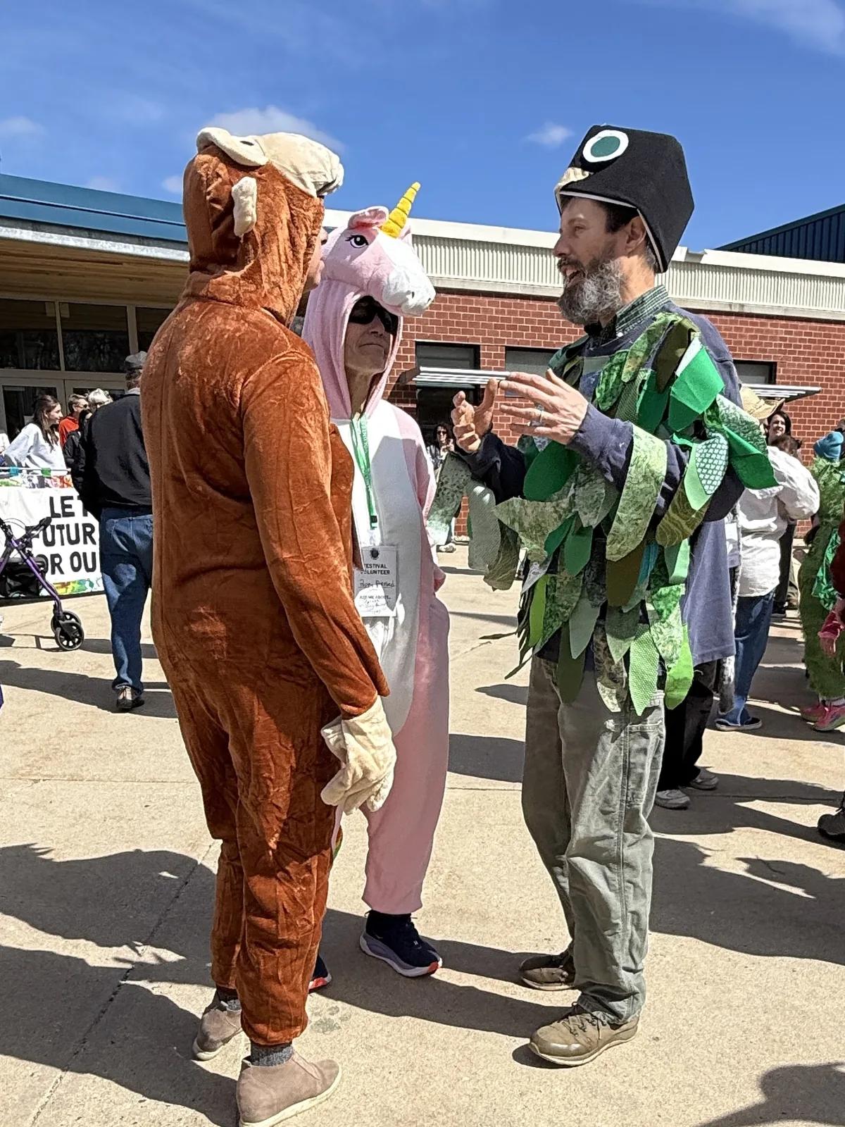 Parade participants in animal costumes gathering before the All Species Parade